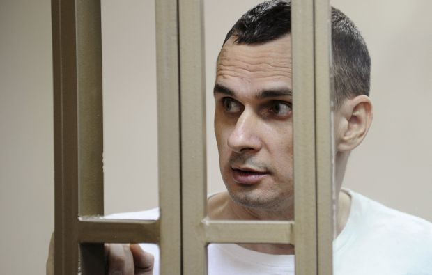 Ukrainian film director Oleg Sentsov looks on from a defendants' cage as he attends a court hearing in Rostov-on-Don, Russia, August 25, 2015. A Russian court on Tuesday sentenced Sentsov to 20 years in a high-security penal colony for "terrorist attacks" in Crimea, the Black Sea peninsula that Moscow annexed from Ukraine in April 2014, RIA news agency said. REUTERS/Sergey Pivovarov